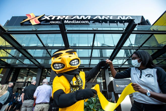 Herky the Hawk bumps fists with Iowa volleyball head coach Vicki Brown during a ribbon cutting event, Thursday, Sept. 17, 2020, at the Xtream Arena in Coralville, Iowa.