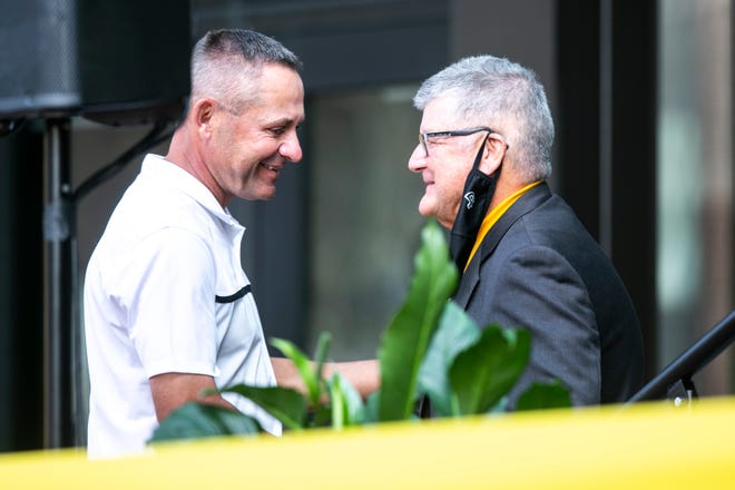 Dickson Jensen, founder of All Iowa Attack Basketball, left, greets Gary Dolphin before speaking during a ribbon cutting event, Thursday, Sept. 17, 2020, at the Xtream Arena in Coralville, Iowa.