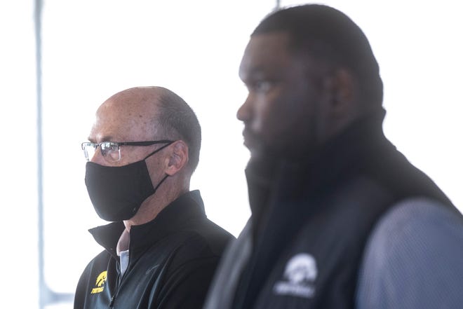 Iowa assistant defensive line coach and defensive recruiting coordinator Jay Niemann, left, wears a face mask while standing next to Iowa defensive line coach Kelvin Bell during a Hawkeye football media day news conference, Thursday, Oct. 8, 2020, at Kinnick Stadium in Iowa City, Iowa.