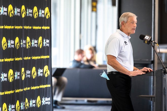 A face mask hangs out of the pocket of Iowa head coach Kirk Ferentz during a Hawkeye football media day news conference, Thursday, Oct. 8, 2020, at Kinnick Stadium in Iowa City, Iowa.