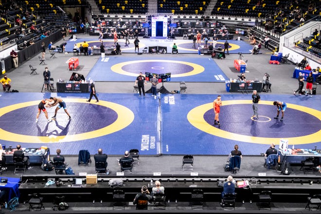 Greco-Roman wrestlers compete on four mats during the opening session of the USA Wrestling Senior National Championships, Friday, Oct. 9, 2020, at the Xtream Arena in Coralville, Iowa.
