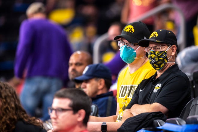 Iowa Hawkeye fans wearing face masks sit in the stands during the USA Wrestling Senior National Championships, Saturday, Oct. 10, 2020, at the Xtream Arena in Coralville, Iowa.