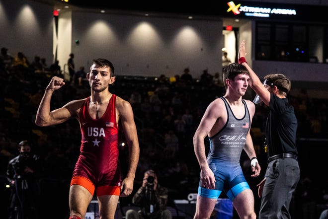 Vitali Arujau, left, flexes after beating Dylan Ragusin in the 57 kg final during the USA Wrestling Senior National Championships, Sunday, Oct. 11, 2020, at the Xtream Arena in Coralville, Iowa.