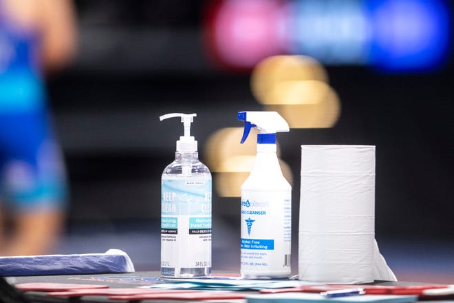 Bottles of disinfectant are seen during the USA Wrestling Senior National Championships, Friday, Oct. 9, 2020, at the Xtream Arena in Coralville, Iowa.