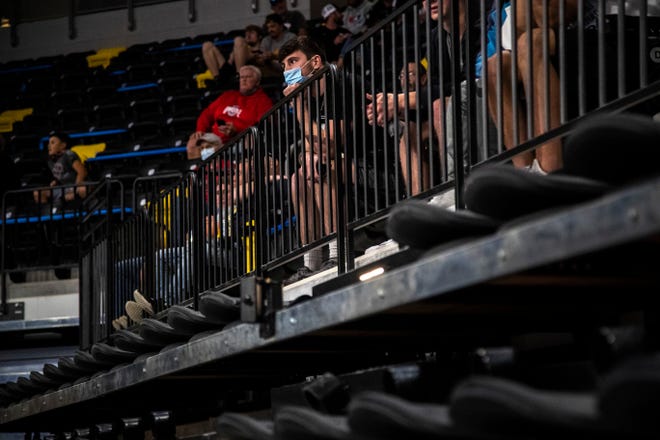 People wear face masks in the stands during the USA Wrestling Senior National Championships, Saturday, Oct. 10, 2020, at the Xtream Arena in Coralville, Iowa.