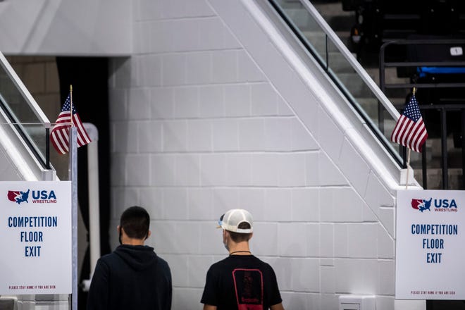 Athletes walk out of the exit to the arena during the USA Wrestling Senior National Championships, Friday, Oct. 9, 2020, at the Xtream Arena in Coralville, Iowa.