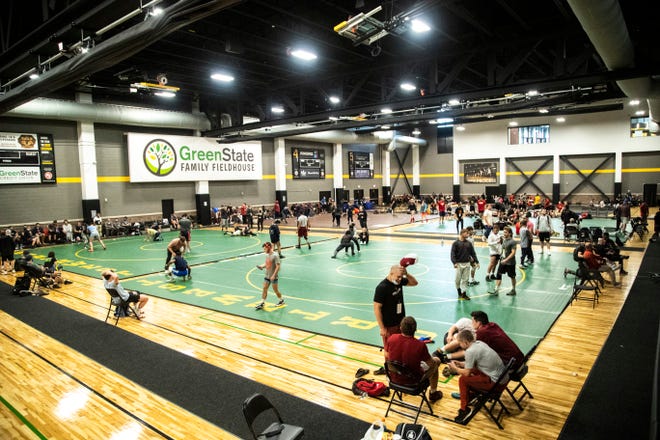 Wrestlers warm up on mats in the GreenState Family Fieldhouse during the USA Wrestling Senior National Championships, Saturday, Oct. 10, 2020, at the Xtream Arena in Coralville, Iowa.