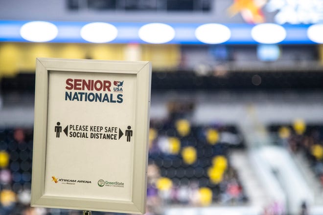 A sign reads, "Please keep safe social distance," during the USA Wrestling Senior National Championships, Saturday, Oct. 10, 2020, at the Xtream Arena in Coralville, Iowa.
