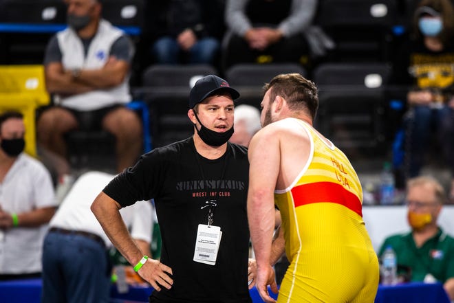 Sunkist Kids Wrestling Club head coach Mark Perry talks with Tanner Hall during the USA Wrestling Senior National Championships, Saturday, Oct. 10, 2020, at the Xtream Arena in Coralville, Iowa.