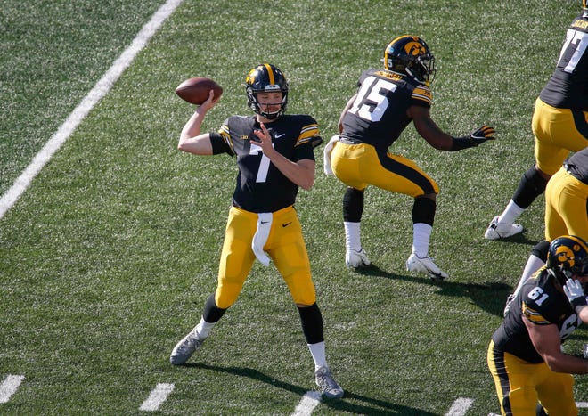 Iowa sophomore quarterback Spencer Petras tosses a touchdown pass to receiver Brandon Smith in the first quarter against Northwestern at Kinnick Stadium in Iowa City on Saturday, Oct. 31, 2020.