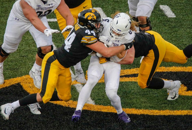 Iowa sophomore linebacker Seth Benson tackles Northwestern's Drake Anderson at Kinnick Stadium in Iowa City on Saturday, Oct. 31, 2020.