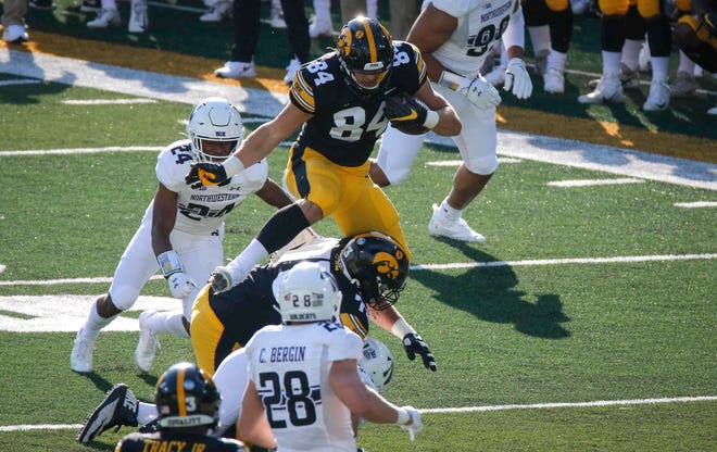 Iowa sophomore tight end Sam LaPorta hurdles players in the first quarter against Northwestern at Kinnick Stadium in Iowa City on Saturday, Oct. 31, 2020.