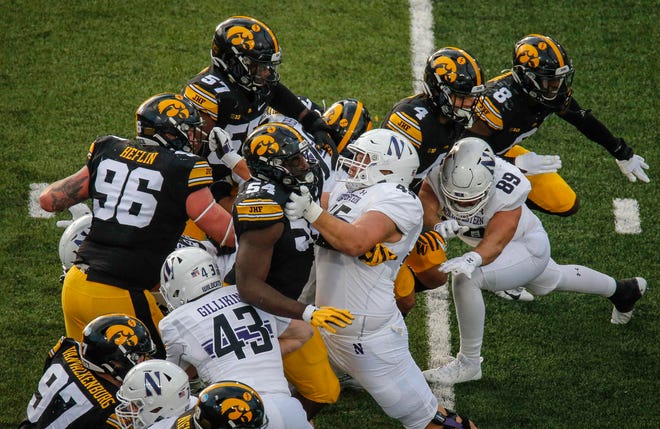 Members of the Iowa defense battle at the line of scrimmage against Northwestern at Kinnick Stadium in Iowa City on Saturday, Oct. 31, 2020.