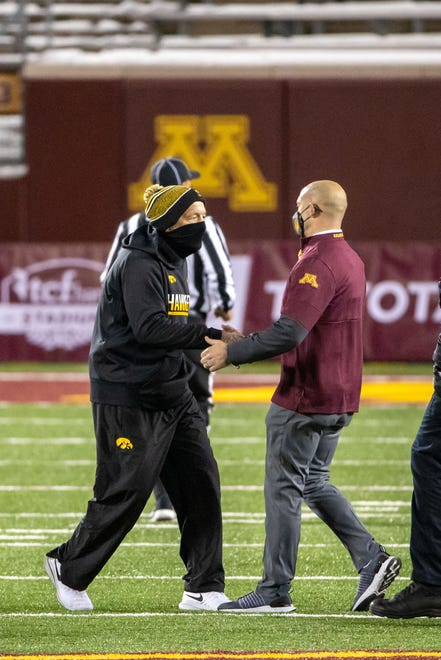 Nov 13, 2020; Minneapolis, Minnesota, USA; Iowa Hawkeyes head coach Kirk Ferentz and Minnesota Golden Gophers head coach P.J. Fleck shake hands at the middle of the field after the game at TCF Bank Stadium. Mandatory Credit: Jesse Johnson-USA TODAY Sports