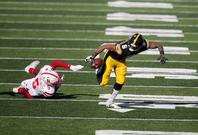 Iowa receiver Ihmir Smith-Marsette maintains his balance for extra yards in the second quarter against Nebraska at Kinnick Stadium in Iowa City on Friday, Nov. 27, 2020.