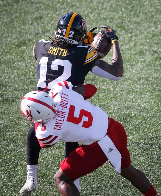 Iowa receiver Brandon Smith catches the ball as he is hit by Nebraska cornerback Cam Taylor-Britt in the third quarter at Kinnick Stadium in Iowa City on Friday, Nov. 27, 2020.