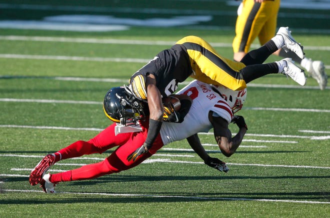 Iowa running back Tyler Goodson is upended by Nebraska safety Deontai Williams in the fourth quarter at Kinnick Stadium in Iowa City on Friday, Nov. 27, 2020.