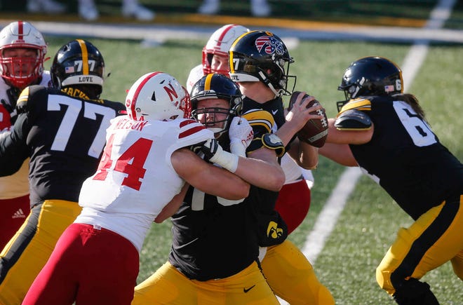 Members of the Iowa offensive line protect quarterback Spencer Petras in the third quarter against Nebraska at Kinnick Stadium in Iowa City on Friday, Nov. 27, 2020.