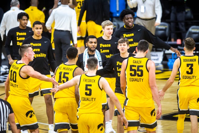 Iowa players Nicolas Hobbs and Austin Ash along with teammates come off the bench to celebrate with Iowa guard CJ Fredrick (5) after a made 3-point basket heading into halftime during a NCAA non-conference men's basketball game in the ACC/Big Ten Challenge, Tuesday, Dec. 8, 2020, at Carver-Hawkeye Arena in Iowa City, Iowa.