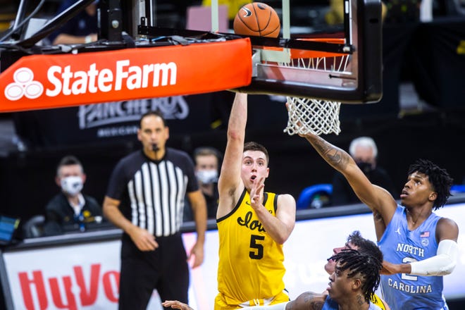 CJ Fredrick, left, scored 21 points in this nonconference win vs. North Carolina on Dec. 8 for the Hawkeyes.