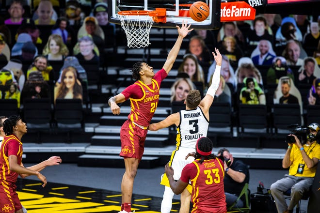 Iowa State guard Jaden Walker (21) blocks a shot from Iowa guard Jordan Bohannon (3) during a NCAA non-conference Cy-Hawk men's basketball game, Friday, Dec. 11, 2020, at Carver-Hawkeye Arena in Iowa City, Iowa.