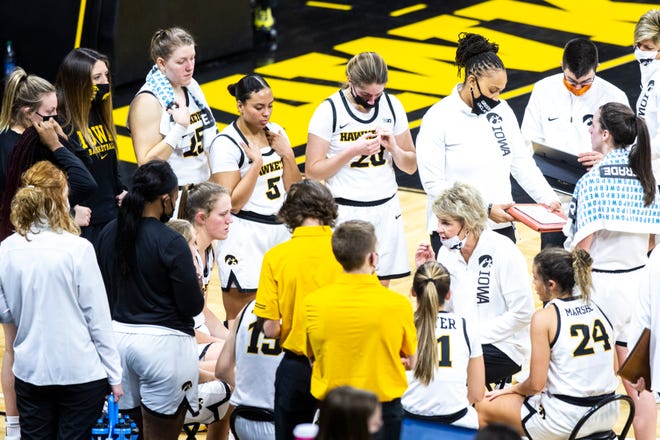 Iowa head coach Lisa Bluder talks with players in a timeout during a NCAA non-conference women's basketball game, Tuesday, Dec. 22, 2020, at Carver-Hawkeye Arena in Iowa City, Iowa.