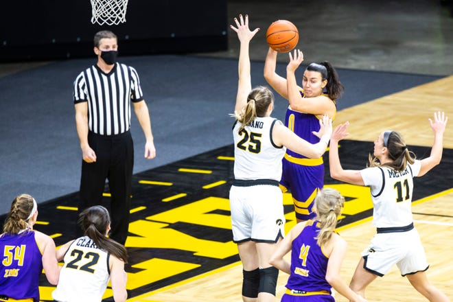 Iowa center Monika Czinano (25) and Iowa guard Megan Meyer (11) defend Western Illinois guard Carla Flores (0) during a NCAA non-conference women's basketball game, Tuesday, Dec. 22, 2020, at Carver-Hawkeye Arena in Iowa City, Iowa.