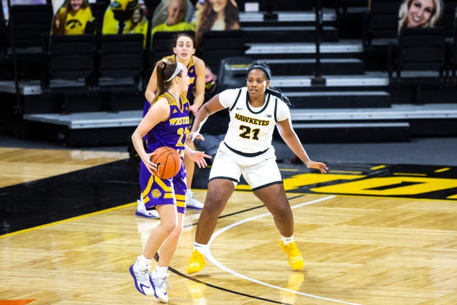 Iowa guard Zion Sanders (21) defends Western Illinois guard Mackenzie Rogers, left, during a NCAA non-conference women's basketball game, Tuesday, Dec. 22, 2020, at Carver-Hawkeye Arena in Iowa City, Iowa.