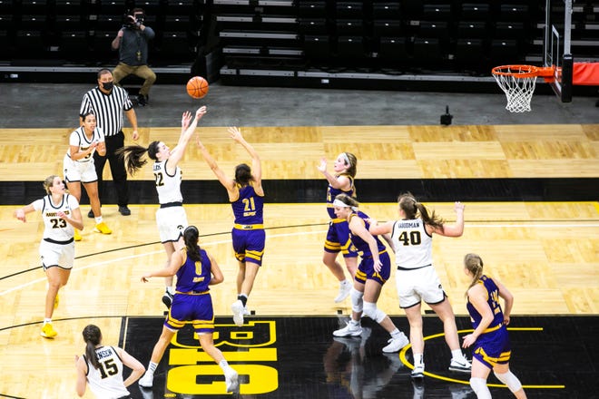 Iowa guard Caitlin Clark (22) makes a basket as Western Illinois guard Grace Gilmore (21) defends during a NCAA non-conference women's basketball game, Tuesday, Dec. 22, 2020, at Carver-Hawkeye Arena in Iowa City, Iowa.