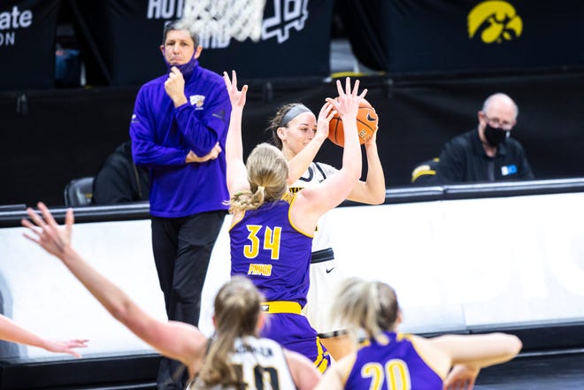 Iowa guard Megan Meyer (11) catches a pass as Western Illinois guard Sam Pryor (34) defends during a NCAA non-conference women's basketball game, Tuesday, Dec. 22, 2020, at Carver-Hawkeye Arena in Iowa City, Iowa.