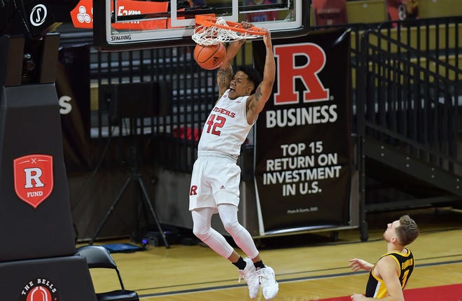 Jan 2, 2021; Piscataway, New Jersey, USA; Rutgers Scarlet Knights guard Jacob Young (42) dunks the ball against the Iowa Hawkeyes during the first half at Rutgers Athletic Center (RAC). Mandatory Credit: Catalina Fragoso-USA TODAY Sports