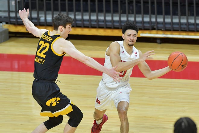 Jan 2, 2021; Piscataway, New Jersey, USA; Rutgers Scarlet Knights guard Geo Baker (0) passes the ball against Iowa Hawkeyes forward Patrick McCaffery (22) during the first half at Rutgers Athletic Center (RAC). Mandatory Credit: Catalina Fragoso-USA TODAY Sports