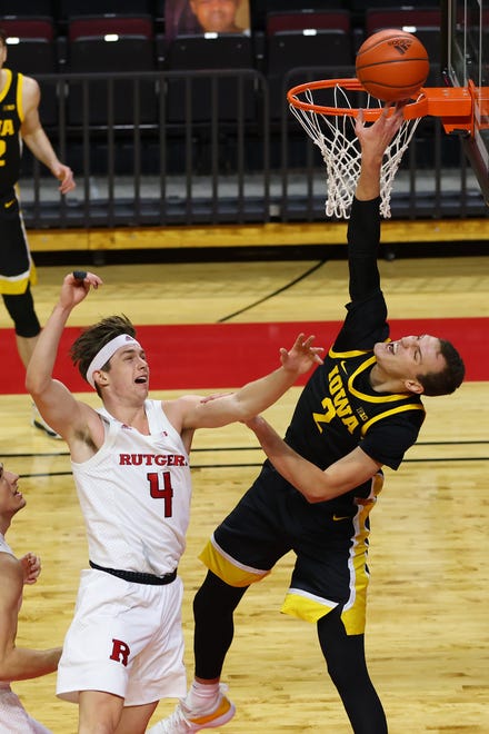 PISCATAWAY, NJ - JANUARY 02: Jack Nunge #2 of the Iowa Hawkeyes attempts a shot as Paul Mulcahy #4 of the Rutgers Scarlet Knights defends during the first half of a college basketball game at Rutgers Athletic Center on January 2, 2021 in Piscataway, New Jersey.