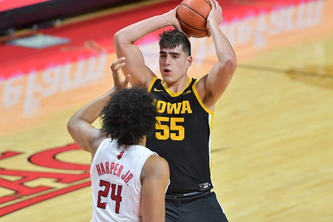 Jan 2, 2021; Piscataway, New Jersey, USA; Iowa Hawkeyes center Luka Garza (55) looks to pass against Rutgers Scarlet Knights guard Ron Harper Jr.
(24) during the first half at Rutgers Athletic Center (RAC). Mandatory Credit: Catalina Fragoso-USA TODAY Sports
