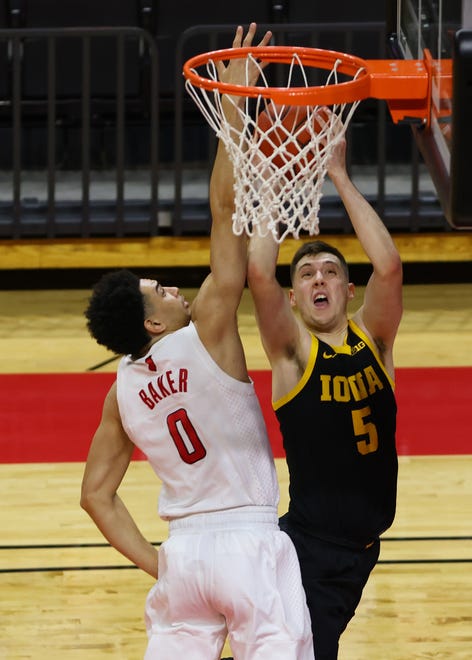 PISCATAWAY, NJ - JANUARY 02: CJ Fredrick #5 of the Iowa Hawkeyes attempts a shot as Geo Baker #0 of the Rutgers Scarlet Knights defends during the first half of a college basketball game at Rutgers Athletic Center on January 2, 2021 in Piscataway, New Jersey.