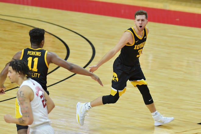 Jan 2, 2021; Piscataway, New Jersey, USA; Iowa Hawkeyes guard Jordan Bohannon (3) and guard Tony Perkins (11) react during a game against the Rutgers Scarlet Knights during the first half at Rutgers Athletic Center (RAC). Mandatory Credit: Catalina Fragoso-USA TODAY Sports