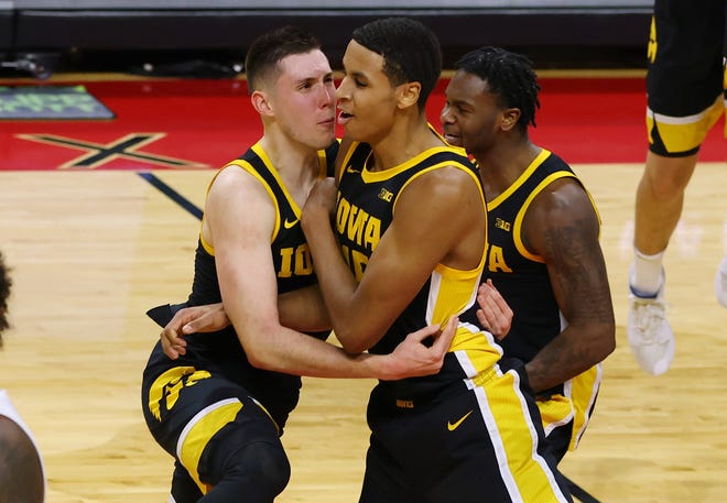 PISCATAWAY, NJ - JANUARY 02:  CJ Fredrick #5 and Keegan Murray #15 of the Iowa Hawkeyes celebrate their 77-75 win over the Rutgers Scarlet Knights in a college basketball game at Rutgers Athletic Center on January 2, 2021 in Piscataway, New Jersey.