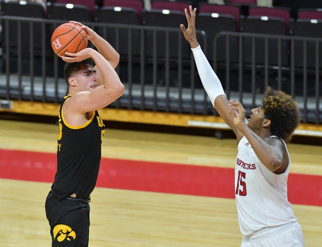 Jan 2, 2021; Piscataway, New Jersey, USA; Iowa Hawkeyes center Luka Garza (55) shoots the ball against Rutgers Scarlet Knights center Myles Johnson (15) during the first half at Rutgers Athletic Center (RAC). Mandatory Credit: Catalina Fragoso-USA TODAY Sports