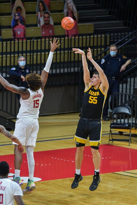 Jan 2, 2021; Piscataway, New Jersey, USA; Iowa Hawkeyes center Luka Garza (55) shoots the ball against Rutgers Scarlet Knights center Myles Johnson (15) during the second half at Rutgers Athletic Center (RAC). Mandatory Credit: Catalina Fragoso-USA TODAY Sports