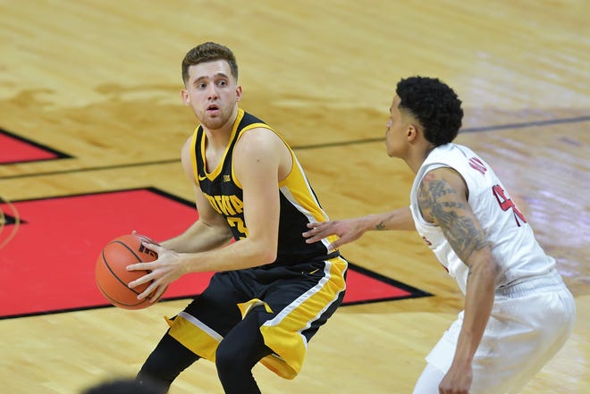 Jan 2, 2021; Piscataway, New Jersey, USA; Iowa Hawkeyes guard Jordan Bohannon (3) looks to pass the ball against Rutgers Scarlet Knights guard Jacob Young (42) during the first half at Rutgers Athletic Center (RAC). Mandatory Credit: Catalina Fragoso-USA TODAY Sports