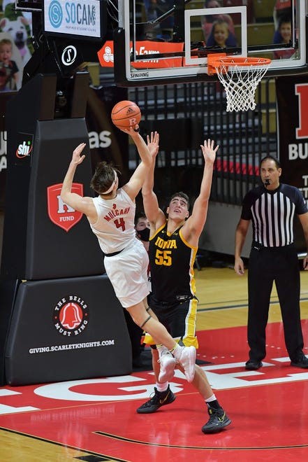 Jan 2, 2021; Piscataway, New Jersey, USA; Rutgers Scarlet Knights guard Paul Mulcahy (4) shoots the ball against Iowa Hawkeyes center Luka Garza (55) during the first half at Rutgers Athletic Center (RAC). Mandatory Credit: Catalina Fragoso-USA TODAY Sports