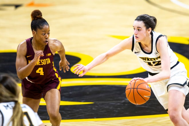 Iowa guard Caitlin Clark (22) dribbles as Minnesota guard Jasmine Powell (4) defends during a NCAA Big Ten Conference women's basketball game, Wednesday, Jan. 6, 2021, at Carver-Hawkeye Arena in Iowa City, Iowa.