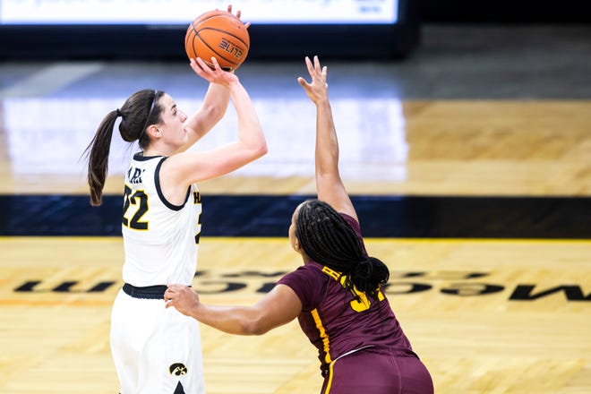 Iowa guard Caitlin Clark (22) makes a 3-point basket as Minnesota guard Gadiva Hubbard, right, defends during a NCAA Big Ten Conference women's basketball game, Wednesday, Jan. 6, 2021, at Carver-Hawkeye Arena in Iowa City, Iowa.