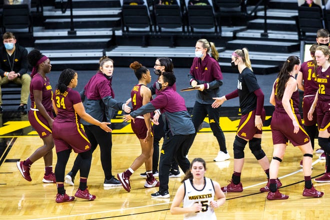 Minnesota head coach Lindsay Whalen high-fives players heading into a timeout in the fourth quarter during a NCAA Big Ten Conference women's basketball game, Wednesday, Jan. 6, 2021, at Carver-Hawkeye Arena in Iowa City, Iowa.