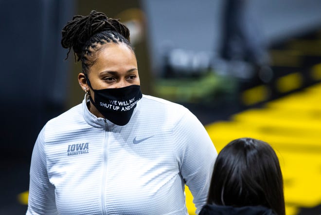 Iowa assistant coach Raina Harmon wears a mask reading, "We will not shut up and dribble," during a NCAA Big Ten Conference women's basketball game, Wednesday, Jan. 6, 2021, at Carver-Hawkeye Arena in Iowa City, Iowa.