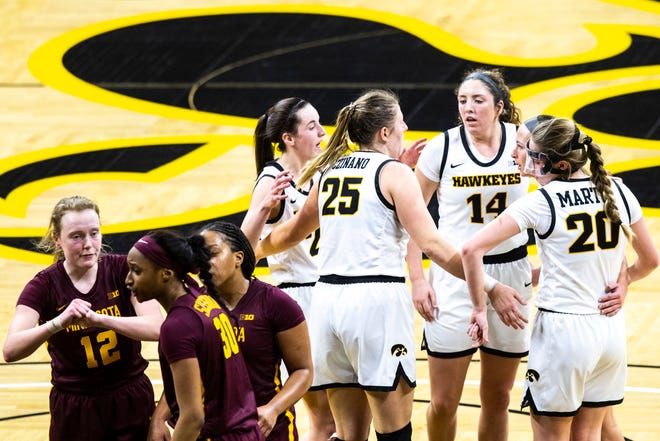 Iowa center Monika Czinano (25) huddles up with teammates Caitlin Clark, left, McKenna Warnock (14) Megan Meyer, second from right, and Kate Martin (20) during a NCAA Big Ten Conference women's basketball game against Minnesota, Wednesday, Jan. 6, 2021, at Carver-Hawkeye Arena in Iowa City, Iowa.
