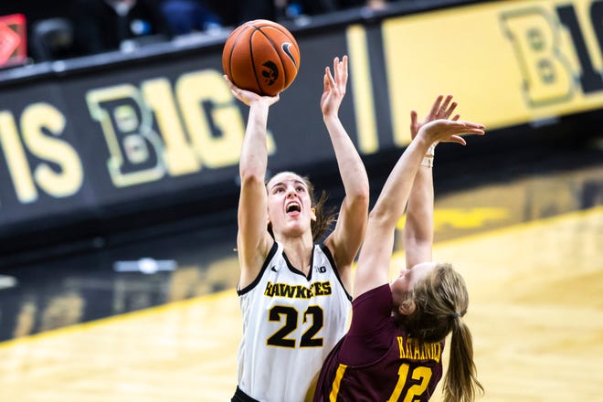 Iowa guard Caitlin Clark (22) makes a basket as Minnesota forward Laura Bagwell Katalinich (12) defends during a NCAA Big Ten Conference women's basketball game, Wednesday, Jan. 6, 2021, at Carver-Hawkeye Arena in Iowa City, Iowa.