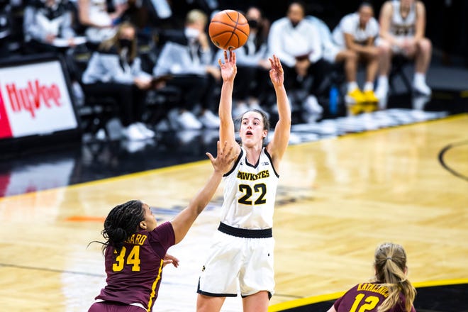 Iowa guard Caitlin Clark (22) makes a 3-point basket as Minnesota guard Gadiva Hubbard (34) defends during a NCAA Big Ten Conference women's basketball game, Wednesday, Jan. 6, 2021, at Carver-Hawkeye Arena in Iowa City, Iowa.