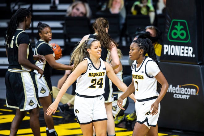 Iowa guard Gabbie Marshall (24) celebrates with teammate Tomi Taiwo, right, during a NCAA Big Ten Conference women's basketball game against Purdue, Monday, Jan. 18, 2021, at Carver-Hawkeye Arena in Iowa City, Iowa.