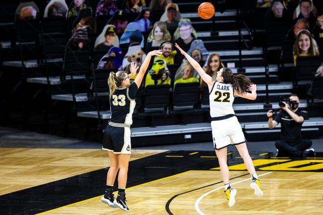 Purdue guard Madison Layden (33) makes a 3-point basket as Iowa guard Caitlin Clark (22) defends during a NCAA Big Ten Conference women's basketball game, Monday, Jan. 18, 2021, at Carver-Hawkeye Arena in Iowa City, Iowa.